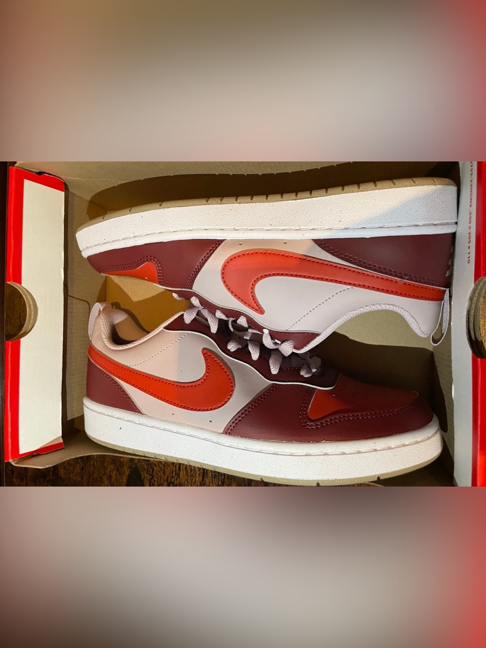 White and Red Low-Top Athletic Sneakers with Orange Swoosh